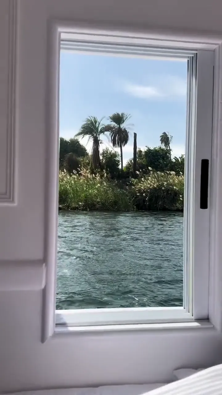 A cabin window opening onto the Nile