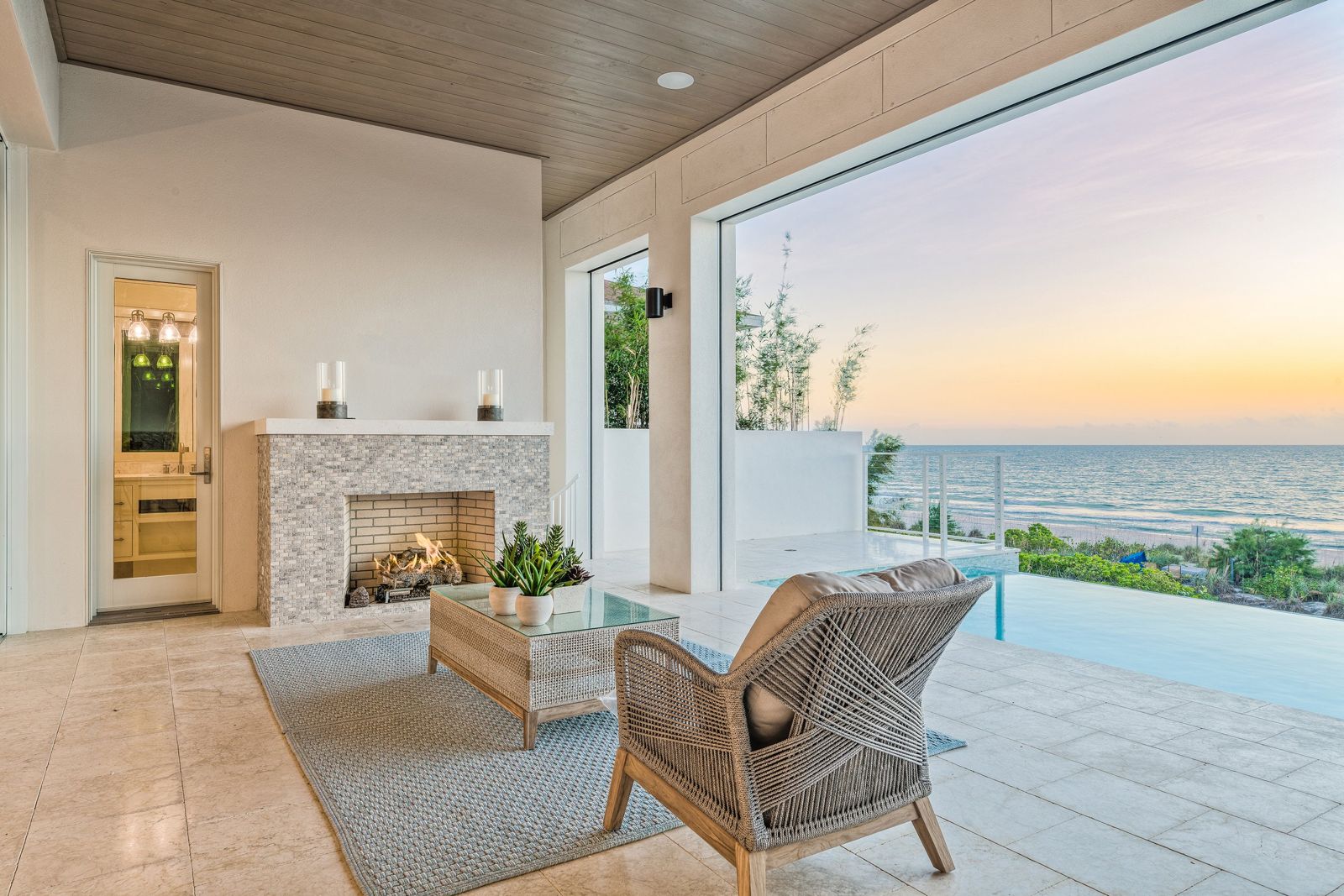Covered terrace with fireplace over the beach