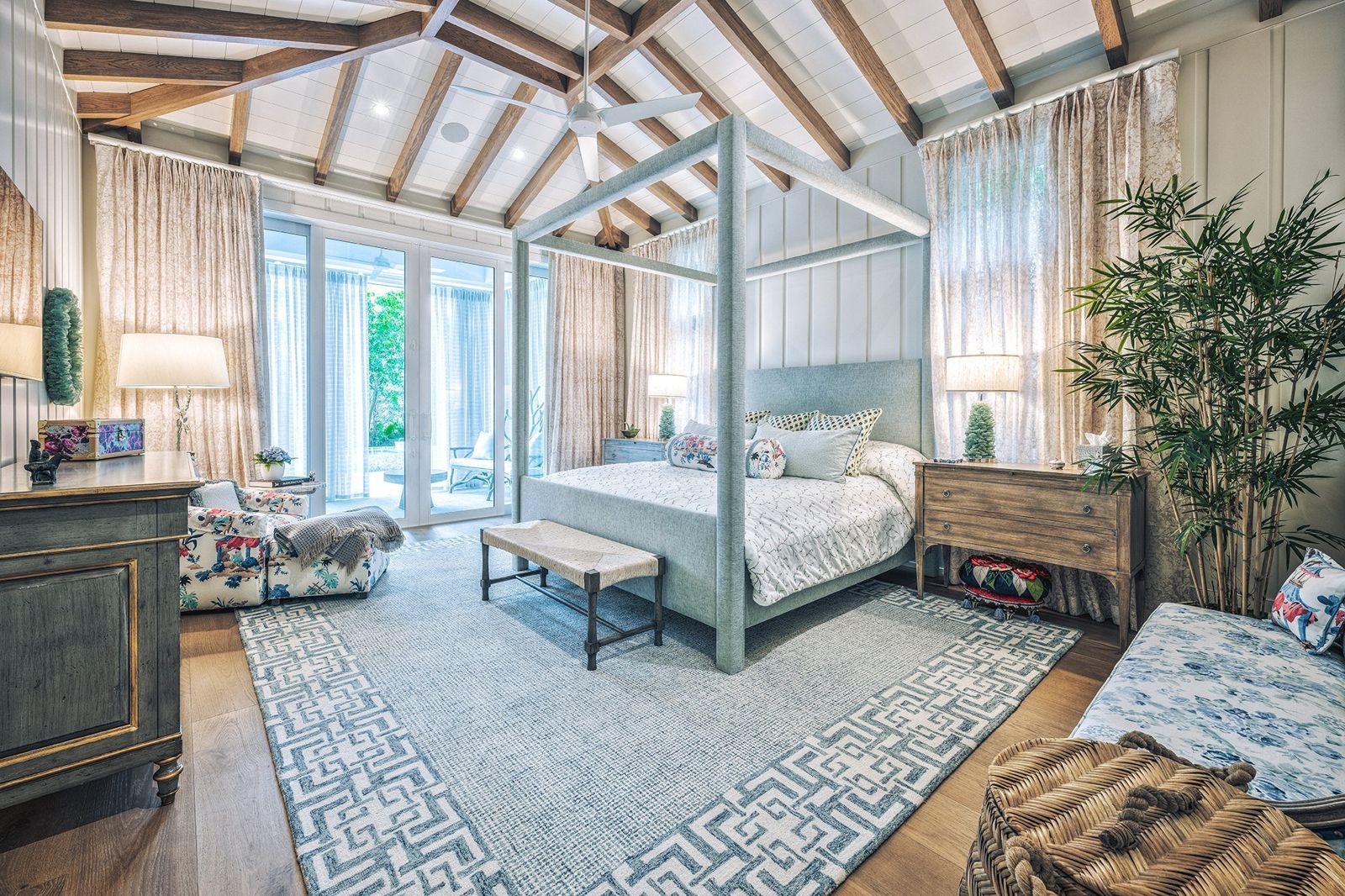 Primary bedroom under a vaulted beamed ceiling