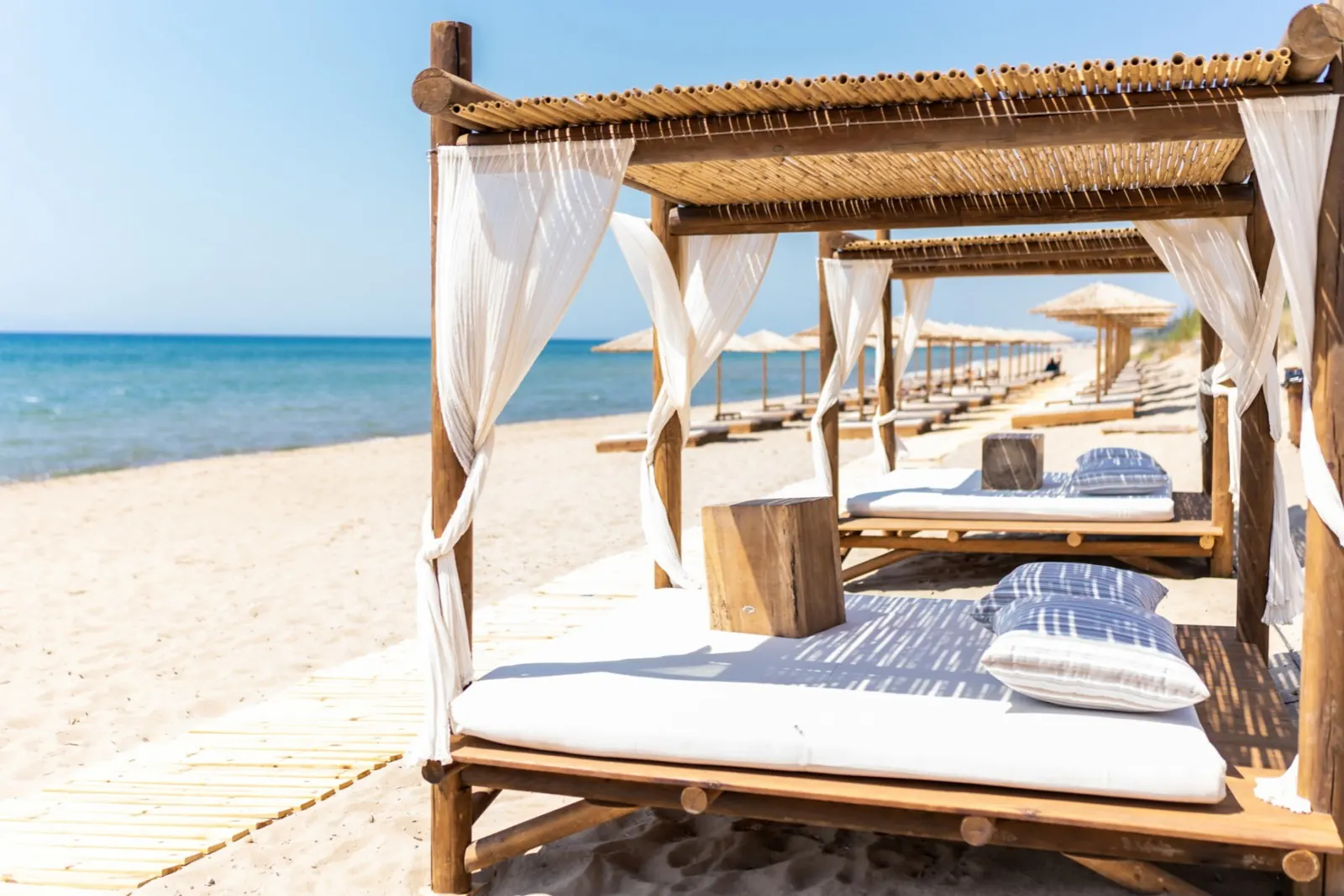 A canopy bed on the hotel's private beach